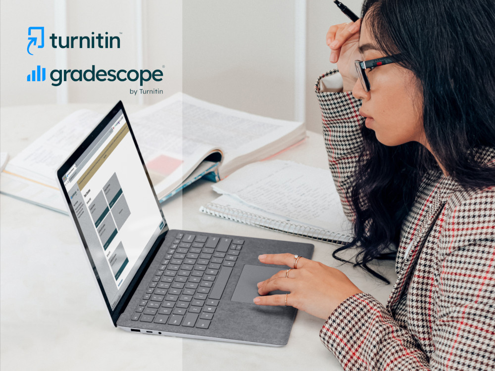 A photo of a woman using Gradescope with Turnitin and Gradescope logos on the top left corner